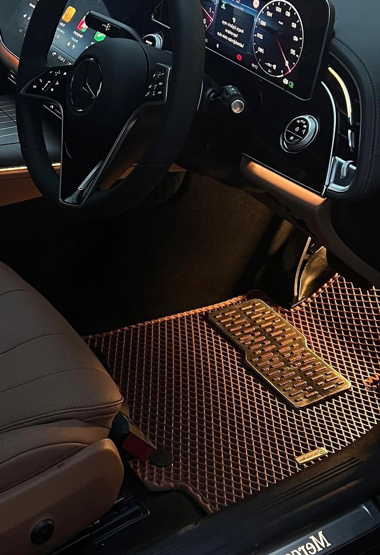 Bronze diamond-pattern EVA mat fitted in the front footwell of a right-hand-drive car