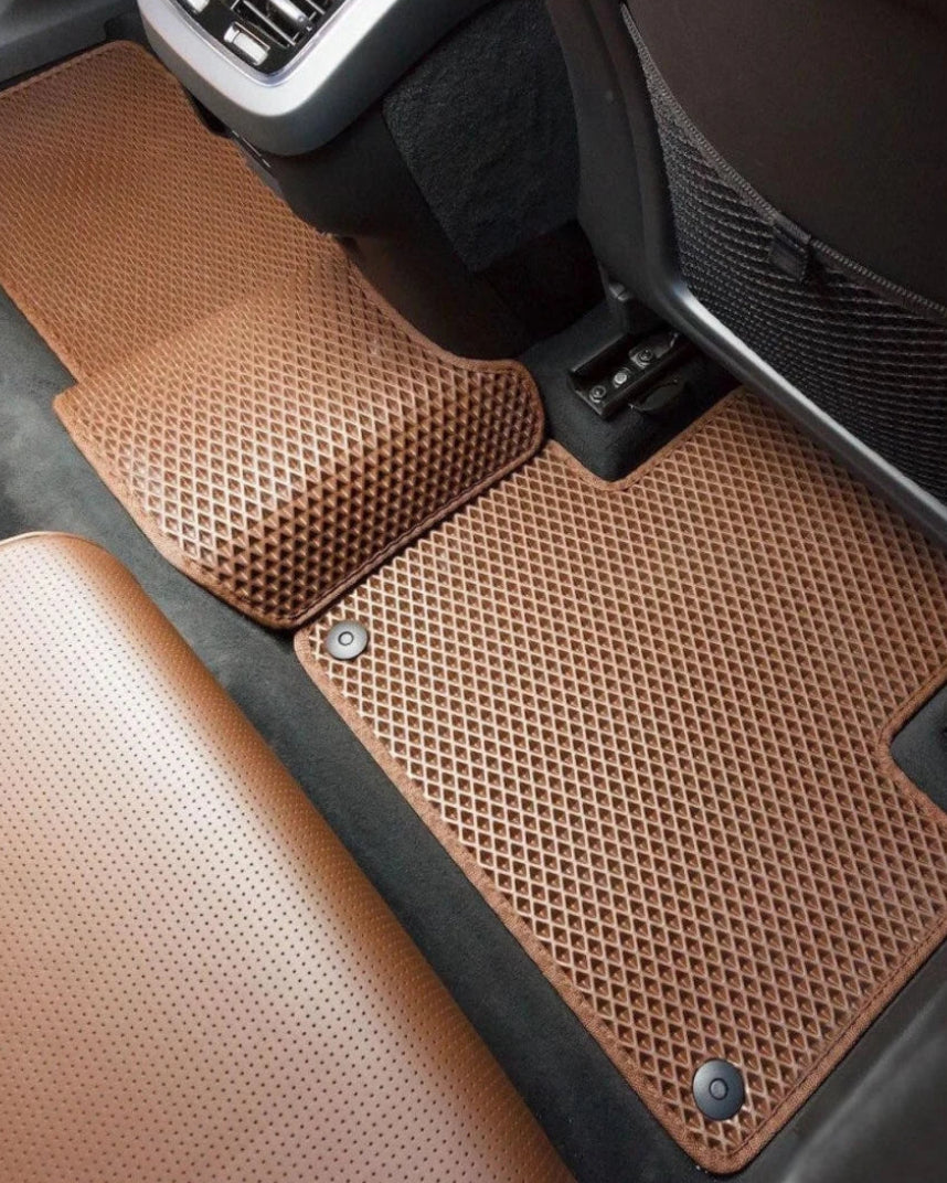 Brown EVA rear car mats fitted around the rear footwells with secure retention clips and tailored floor coverage
